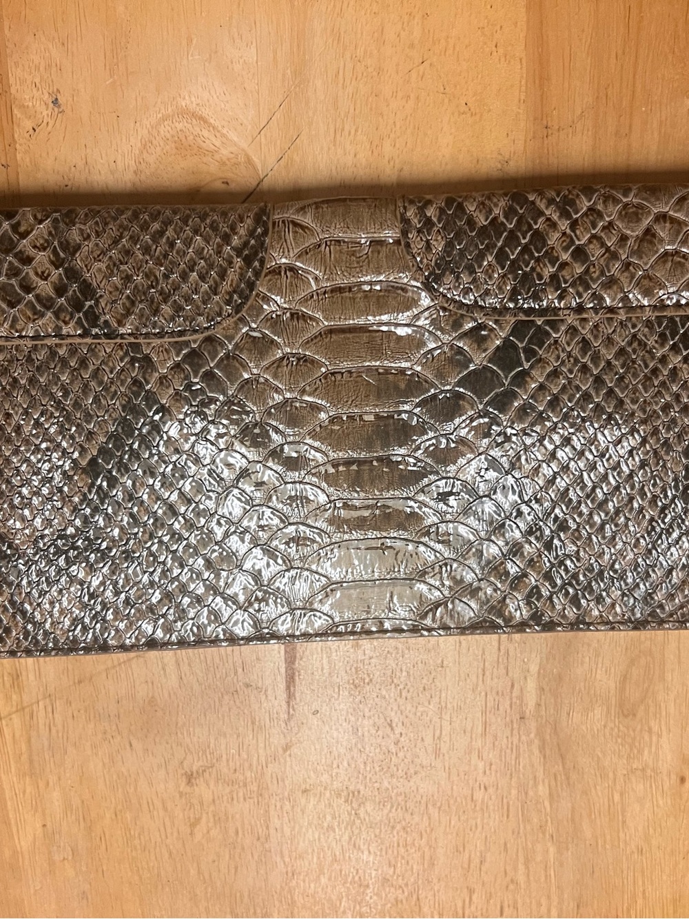 Snake-Embossed Metallic Clutch